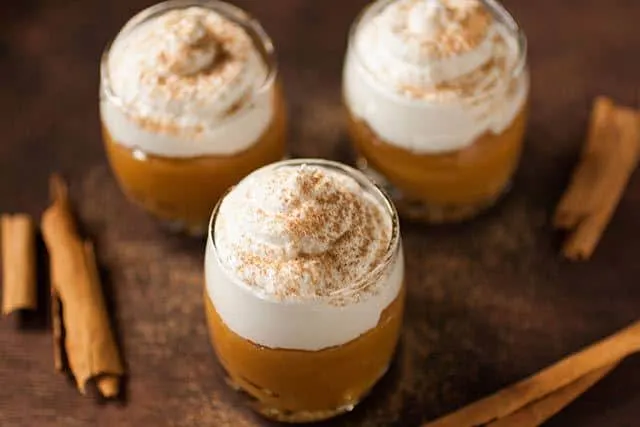 Suspiro de Lime&ntilde;a is a Peruvian dessert that originated in the city of Lima. Creamy, caramel like pudding (dulce de leche) is topped with a Port flavored meringue and sprinkled with a touch of cinnamon. | www.CuriousCuisiniere.com 