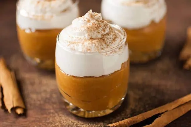 Suspiro de Lime&ntilde;a is a Peruvian dessert that originated in the city of Lima. Creamy, caramel like pudding (dulce de leche) is topped with a Port flavored meringue and sprinkled with a touch of cinnamon. | www.CuriousCuisiniere.com 