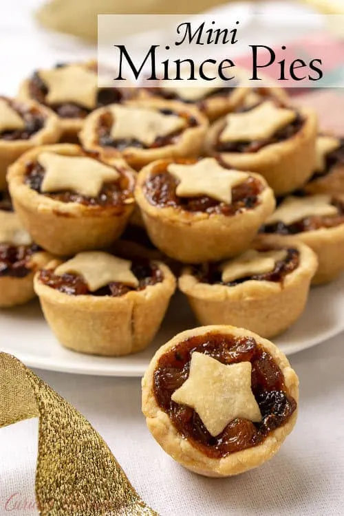 Mince Pies are a British Christmas staple. These sweet and boozy mini fruit pies are the perfect recipe to add to your Holiday cookie platter! | www.CuriousCuisiniere.com
