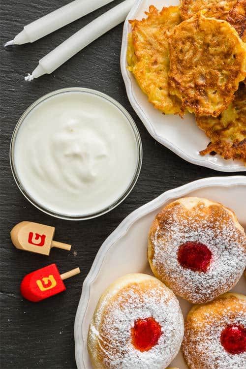 Hanukkah donuts and latke with candles and dreidel