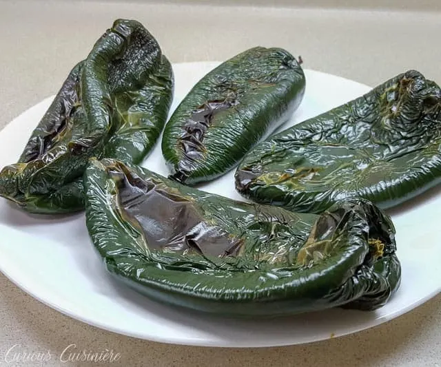 Poblano Chiles roasted and read to make chiles rellenos | www.CuriousCuisiniere.com