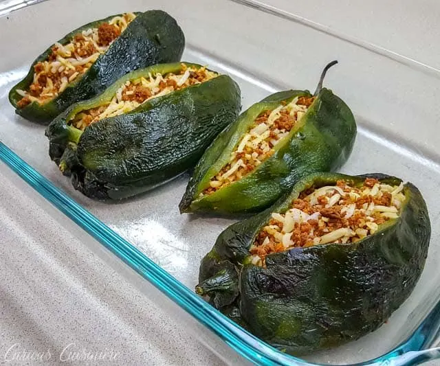 Chiles Rellenos with chorizo and chihuahua cheese ready for the oven. | www.CuriousCuisiniere.com
