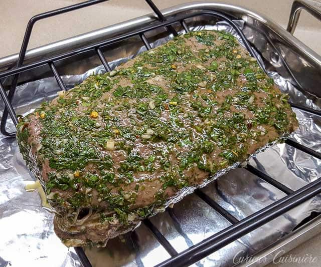 Chimichurri marinated top round beef roast on a roasting rack ready for the oven. | www.CuriousCuisiniere.com 