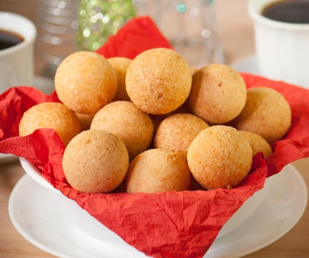 Colombian buñuelos or cheese fritters, are a mouthful of textures and flavors. They have a soft crumb and a crispy crust with a hint of sweetness and are a typical Colombian Christmas treat. | www.CuriousCuisiniere.com