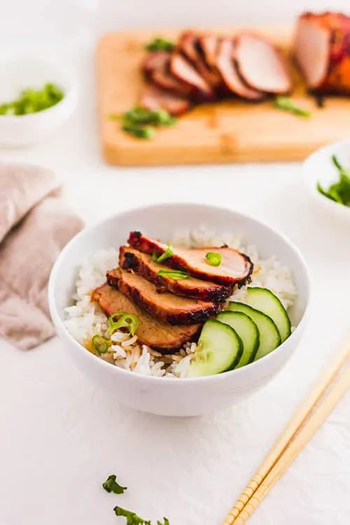 Char Siu over rice with vegetables in a bowl. | www.CuriousCuisiniere.com