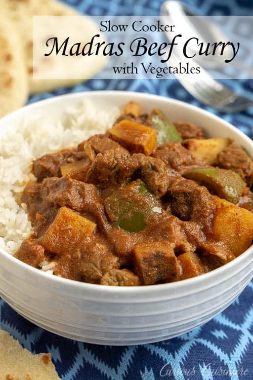 This Madras Curry is a warming dish that is perfect for a cool evening. This slow cooker beef curry brings deep, comforting flavors and tender meat with little effort. | www.CuriousCuisiniere.com