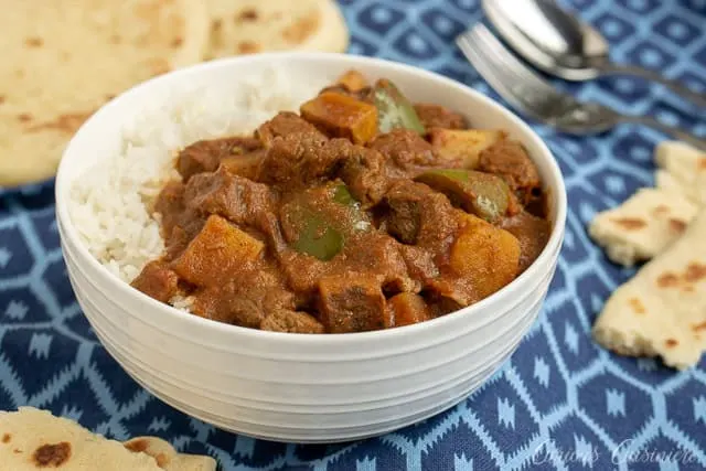 Madras Beef Curry with Vegetables and rice and naan flatbread. | www.CuriousCuisiniere.com
