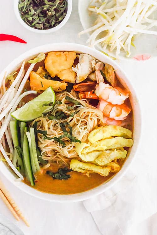 Top down of full sarawak laska bowl soup with chicken and noodles | www.CuriousCuisiniere.com