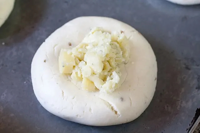 Cassava flour chipa dough with 4 cheese blend on top, before baking. 