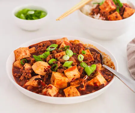A serving bowl of Mapo Tofu, a quick Chinese Sichuan dinner recipe. | www.CuriousCuisiniere.com