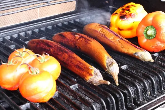 Khorovats (Armenian Grilled Vegetables) tomatoes, Chinese eggplant, and yellow pepper on the grill