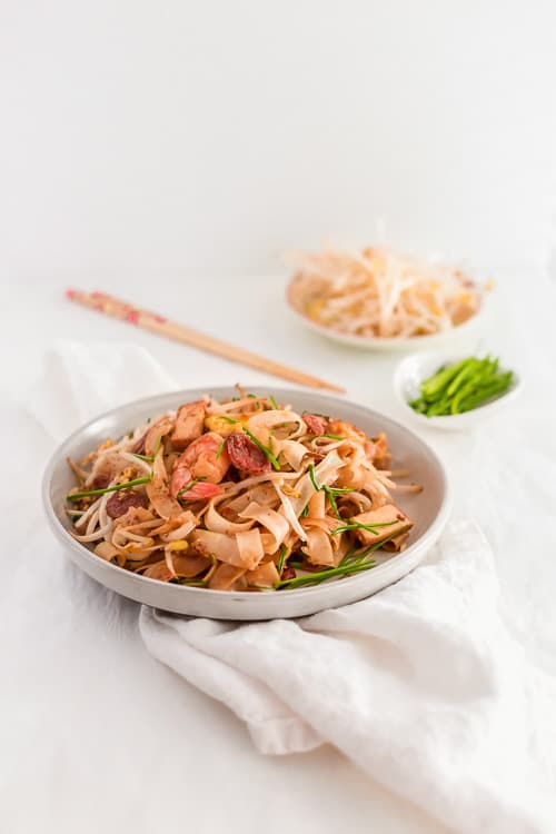 Malaysian Stir Fried Rice Noodles - Char Kway Teow - in a large bowl with shrimp