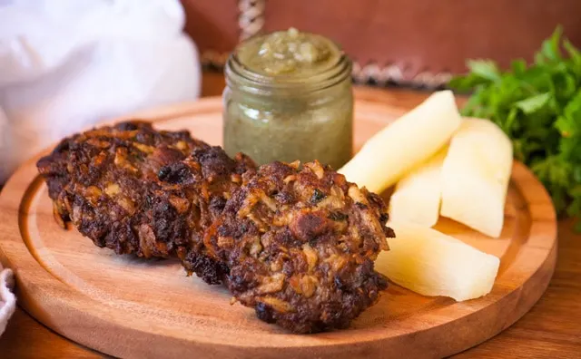 Asaditos (Bolivian Cassava and Beef Fritters) with boiled cassava and spicy sauce