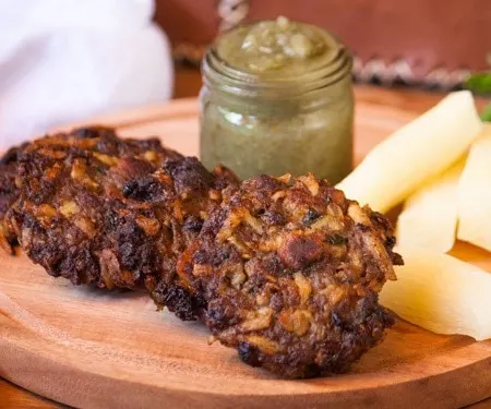 Asaditos (Bolivian Cassava and Beef Fritters) with boiled cassava and spicy sauce