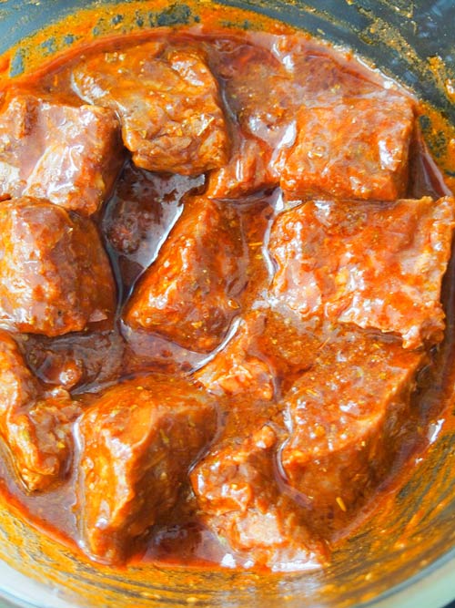 Anticuchos beef in a chili marinade before putting on skewers and grilling