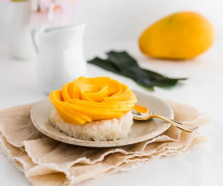 Thai mango sticky rice with decorative mango flower horizontal image small