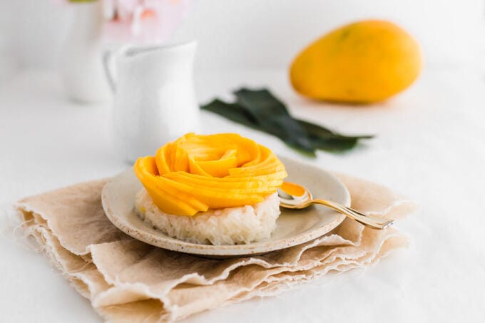 Thai mango sticky rice with decorative mango flower horizontal image