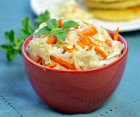 El Salvadoran Curdito pickled cabbage and carrot slaw in a red bowl small image