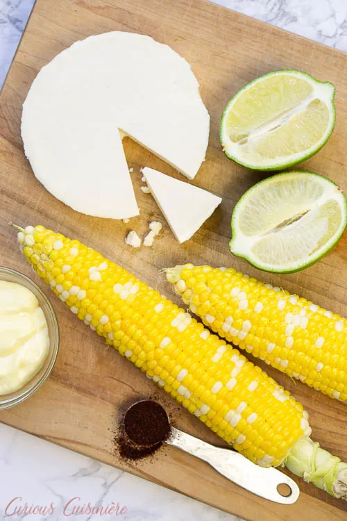 Mexican street corn salad ingredients: corn, chili powder, lime juice, queso fresco, mayonnaise.