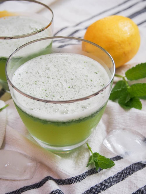 Limonana Middle Eastern Mint Lemonade with mint and lemons in background