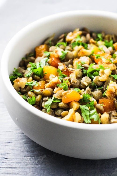 Mshosh Armenian salad with lentils, apricots, and walnuts in a white bowl.