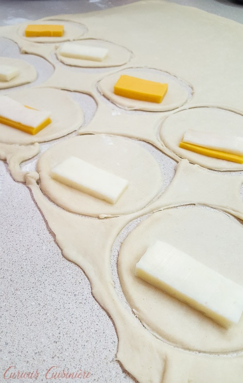 Rolling the dough and filling Brazilian Pastel de Queijo