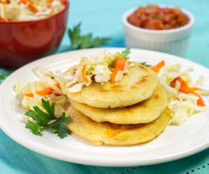 El Salvadoran pupusas, cheese stuffed tortillas, stacked with cabbage slaw on top small image