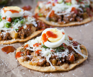 Honduran enchiladas with beef, hard boiled egg, and tomato sauce