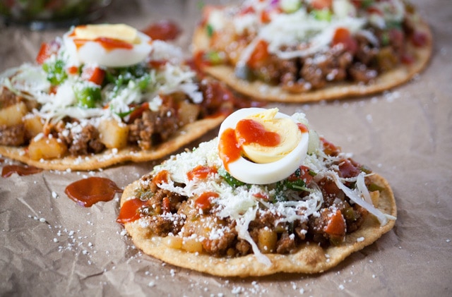 Honduran enchiladas with beef, hard boiled egg, and tomato sauce