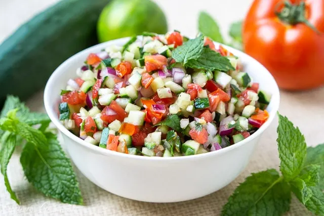 Persian Salad Shirazi, tomato and cucumber salad with lime and mint in a white bowl
