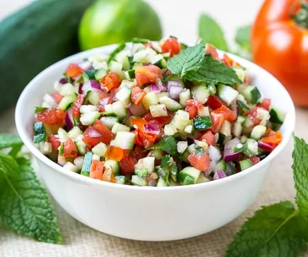 Persian Salad Shirazi, tomato and cucumber salad with lime and mint in a white bowl small image