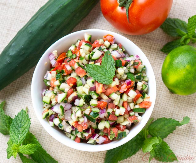 Top down view of Persian Salad Shirazi, tomato and cucumber salad with lime and mint 