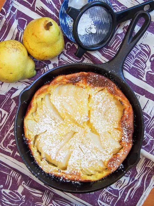 Pear clafoutis overhead picture with powdered sugar.