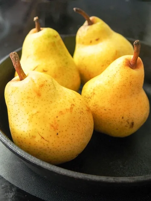 Whole pears for pear clafoutis.