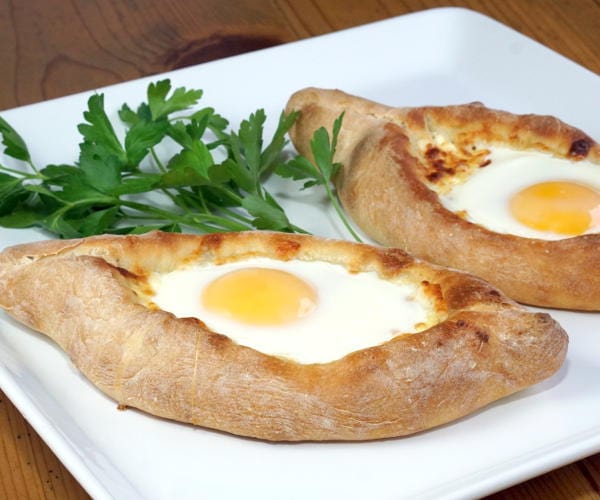 Adjaruli Khachapuri (Georgian Cheese Bread) with soft cooked egg