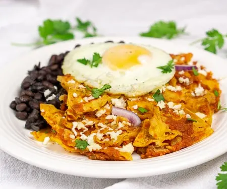 Chilaquiles rojos with black beans and a fried egg