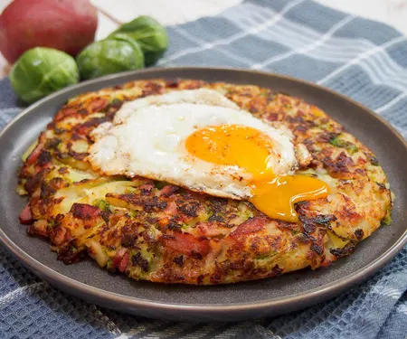 Bubble and Squeak (British Potato Cakes) and an egg with broken yolk