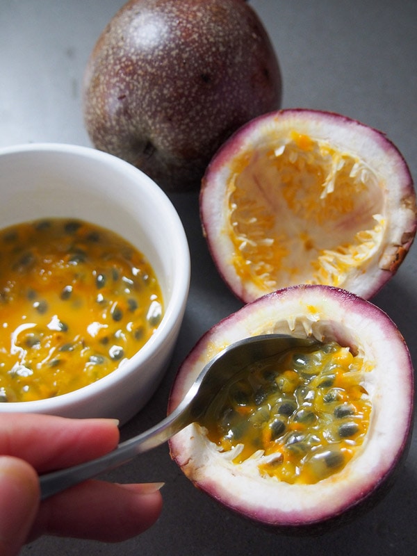 Scooping passion fruit for Australian dessert