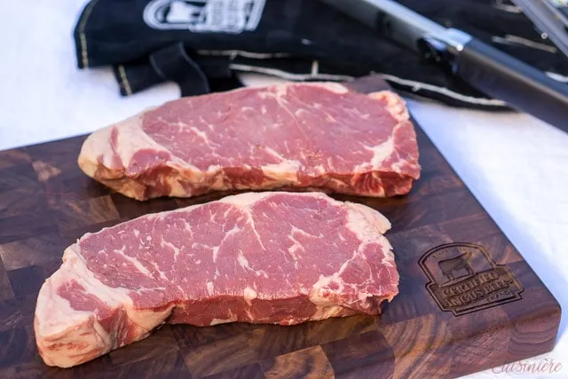 New York Strip Steak on a end grain cutting board