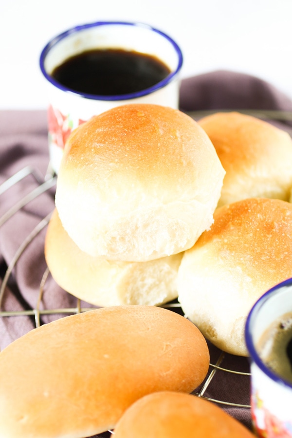 Stacked rolls of Honduran Coconut Bread Pan de Coco with coffee