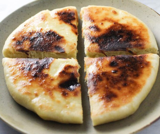 Imeruli Khachapuri - Georgian cheese filled bread cut into quarters