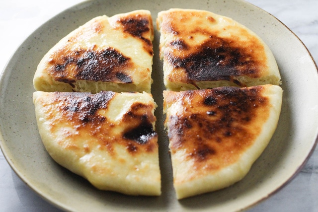 Imeruli Khachapuri - Georgian cheese filled bread cut into quarters