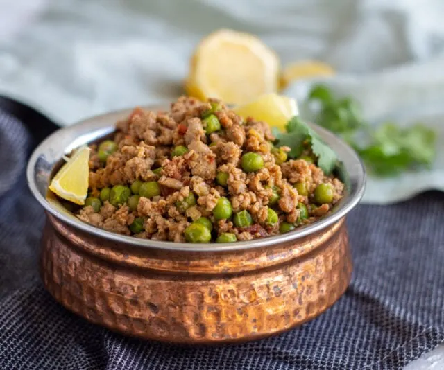 Keema Matar (Pakistani Ground Beef Curry with Peas) on a blue cloth