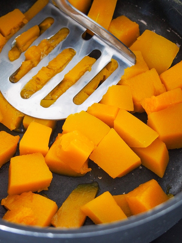 Mashing pumpkin for Indian erissery