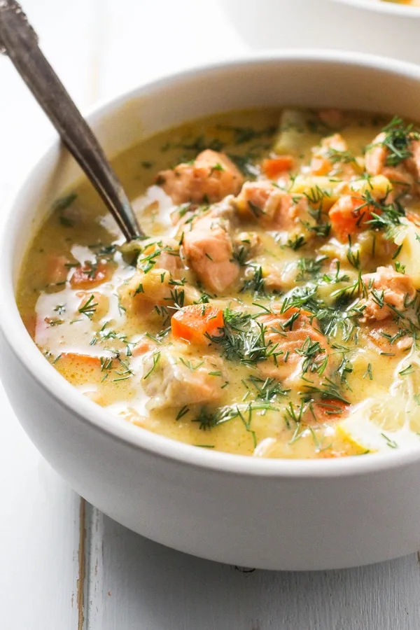 Finnish Salmon Soup - Lohikeitto - in a white bowl with a spoon