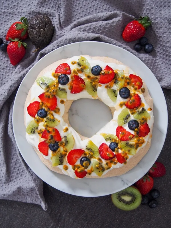 Christmas Pavlova wreath topped with strawberries and kiwi