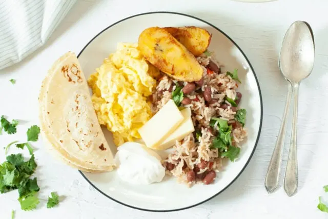 Gallo Pinto (Rice and Beans) for breakfast with eggs, cheese and fried plantains