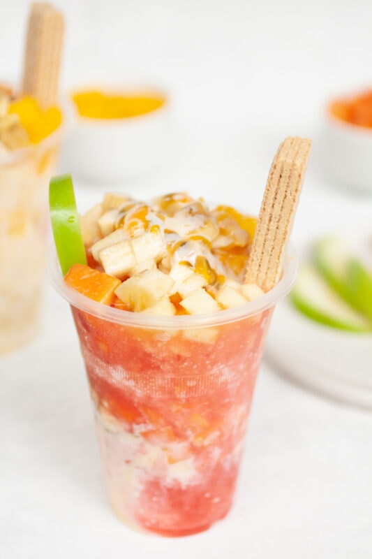Cholados (Colombian snow cones with fruit and condensed milk) with strawberry syrup