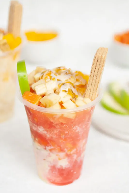 Cholados (Colombian snow cones with fruit and condensed milk) with strawberry syrup
