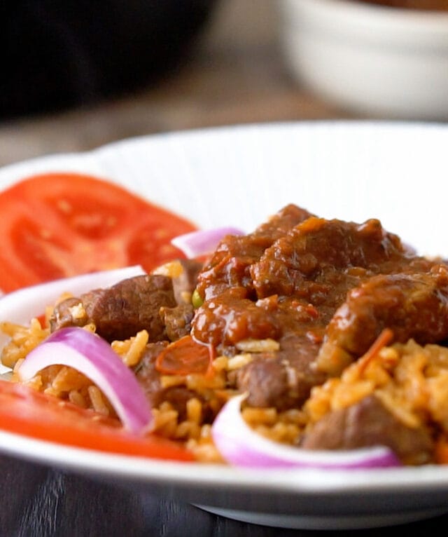 Jollof rice with beef topped with beef stew Ghanaian version
